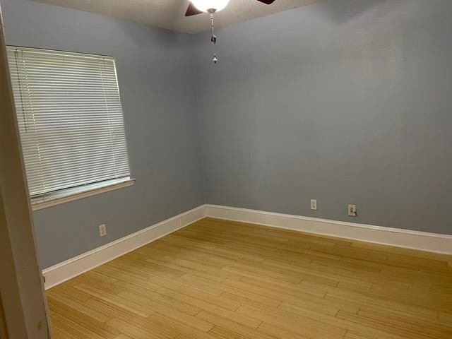 unfurnished room featuring light hardwood / wood-style flooring, ceiling fan, and plenty of natural light