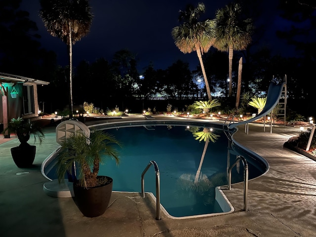 1775 N US-19 Hwy, Perry, FL 32347 - pool at twilight with a patio, an outdoor pool, and a water slide