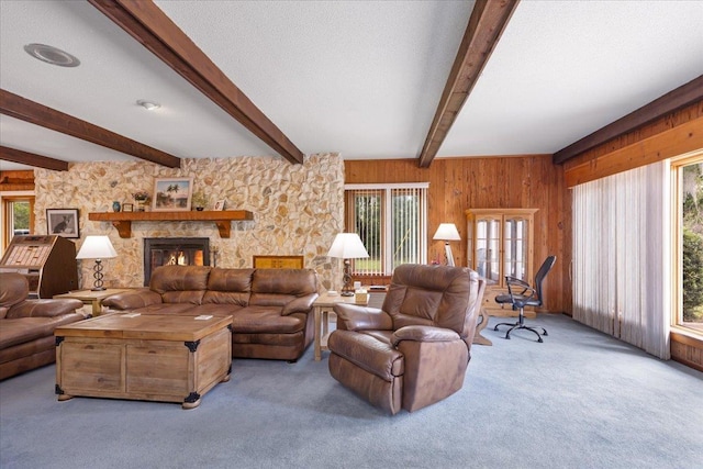 1775 N US-19 Hwy, Perry, FL 32347 - carpeted living area featuring a stone fireplace, wood walls, a wealth of natural light, and beamed ceiling