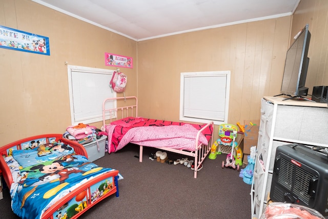 carpeted bedroom with heating unit, crown molding, and wood walls