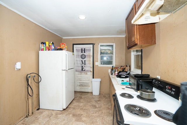kitchen featuring crown molding, extractor fan, and white appliances