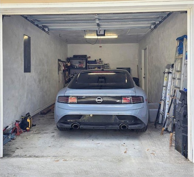 garage featuring a garage door opener and electric panel