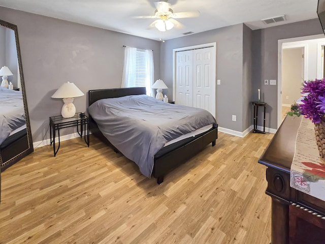 bedroom featuring ceiling fan, a closet, and light wood-type flooring