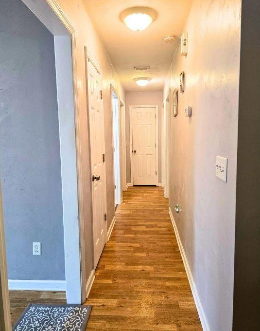 corridor featuring dark hardwood / wood-style flooring