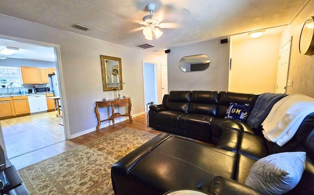 living room with ceiling fan, dark hardwood / wood-style floors, and sink