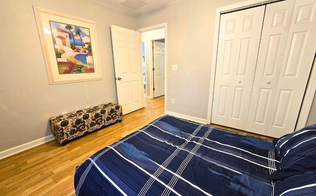 bedroom with wood-type flooring and a closet