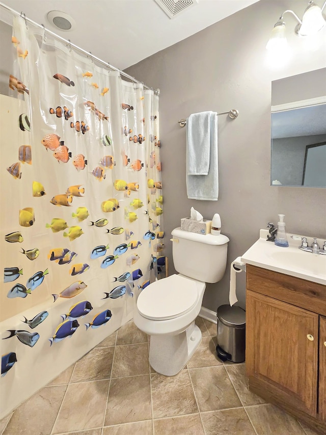 bathroom with a shower with curtain, vanity, toilet, and tile patterned flooring