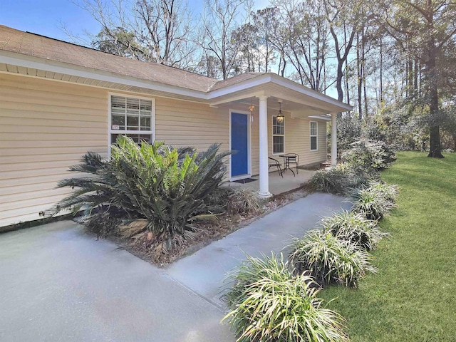 property entrance featuring a lawn