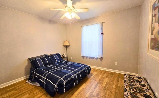 bedroom with hardwood / wood-style floors and ceiling fan