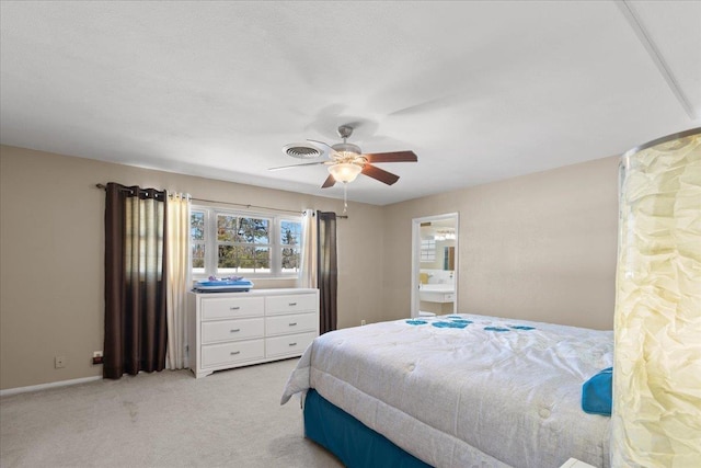 bedroom with light carpet, baseboards, visible vents, a ceiling fan, and ensuite bathroom