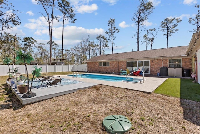 view of swimming pool with a fenced backyard, a lawn, a fenced in pool, and a patio