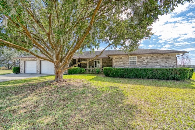 ranch-style house featuring a garage and a front lawn