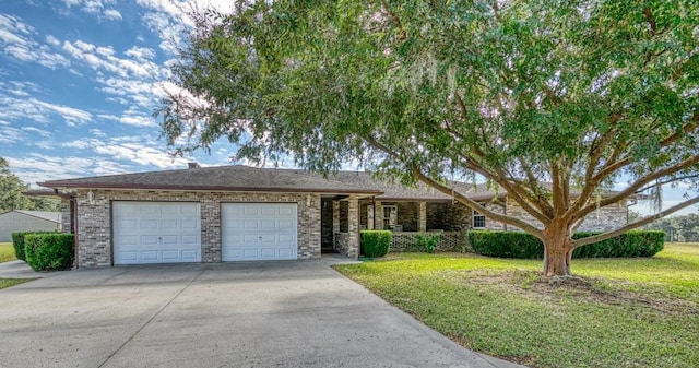 view of front of house with a front yard and a garage