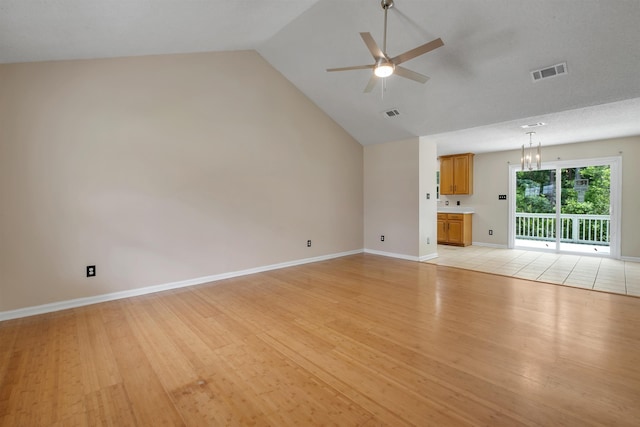 5609 Mossy Top Way, Tallahassee, FL 32303 - unfurnished living room with ceiling fan, light wood-style floors, a chandelier, and high vaulted ceiling