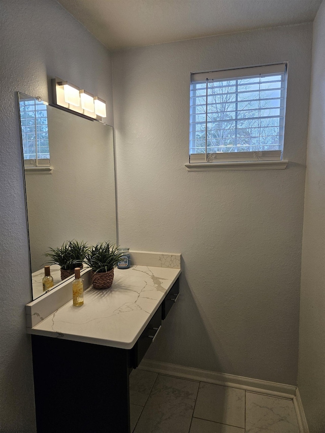 bathroom with tile patterned flooring and baseboards