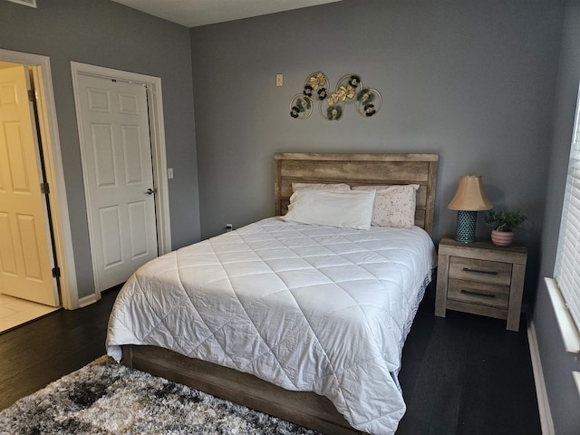 bedroom featuring visible vents and dark wood-style flooring