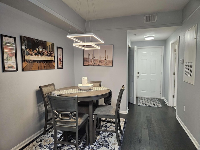 dining room with a chandelier, dark wood-type flooring, visible vents, and baseboards