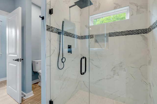279 Ayers Ct, Tallahassee, FL 32305 - bathroom with a marble finish shower, toilet, baseboards, and wood finished floors