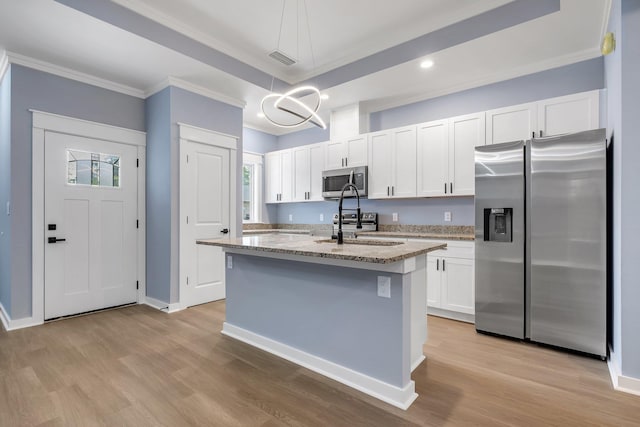 279 Ayers Ct, Tallahassee, FL 32305 - kitchen with appliances with stainless steel finishes, ornamental molding, light stone counters, white cabinets, and a chandelier