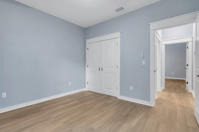 279 Ayers Ct, Tallahassee, FL 32305 - unfurnished bedroom with light wood finished floors, baseboards, and a closet
