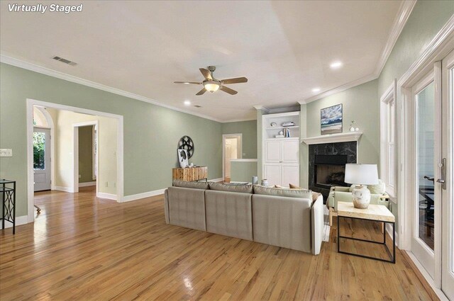 9078 Shoal Creek Dr, Tallahassee, FL 32312 - living area with a high end fireplace, light wood-style floors, a ceiling fan, crown molding, and recessed lighting