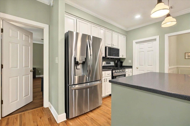 9078 Shoal Creek Dr, Tallahassee, FL 32312 - kitchen with appliances with stainless steel finishes, dark countertops, crown molding, white cabinets, and light wood-style flooring