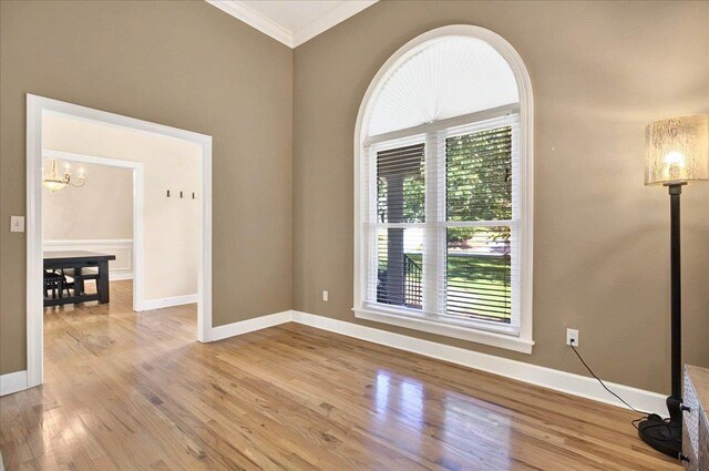 9078 Shoal Creek Dr, Tallahassee, FL 32312 - empty room featuring ornamental molding, a chandelier, light wood-type flooring, and baseboards