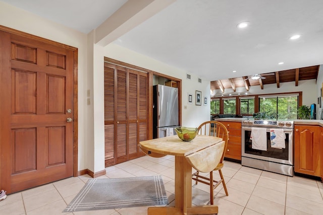 988 Timber Run, Havana, FL 32333 - kitchen with appliances with stainless steel finishes, beamed ceiling, light tile patterned flooring, a ceiling fan, and light countertops