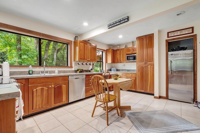 988 Timber Run, Havana, FL 32333 - kitchen featuring appliances with stainless steel finishes, a sink, brown cabinets, light tile patterned floors, and recessed lighting