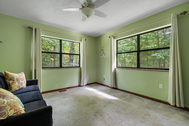 988 Timber Run, Havana, FL 32333 - unfurnished living room with carpet floors, healthy amount of natural light, baseboards, and ceiling fan