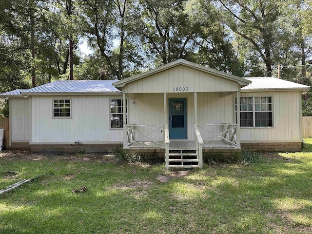 18003 Rakestraw Dr, Tallahassee, FL 32310 - view of front facade featuring a metal roof, a front yard, and a porch