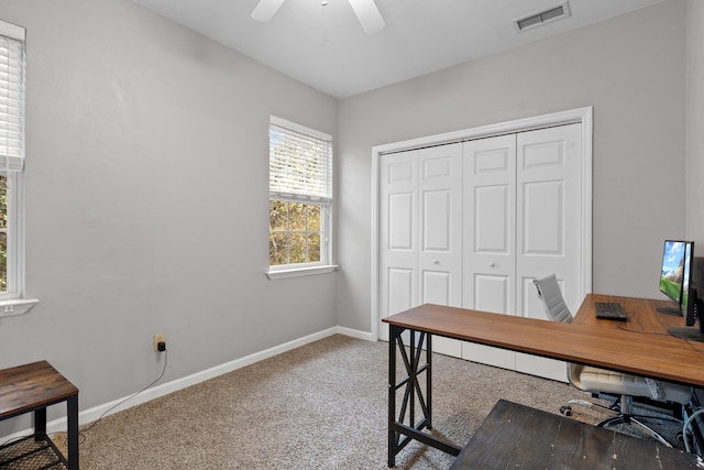 carpeted home office with ceiling fan