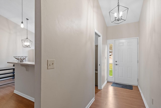 foyer with a notable chandelier and hardwood / wood-style flooring