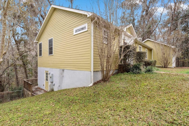 view of property exterior with a yard