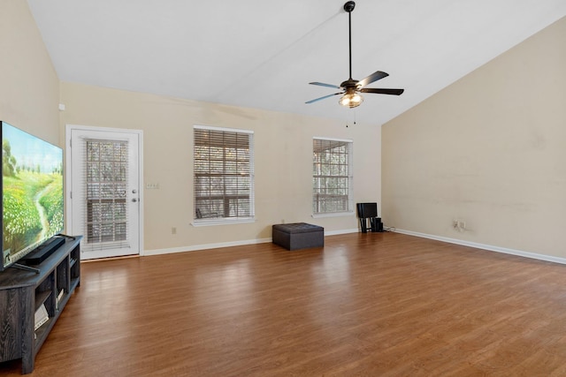 unfurnished living room featuring vaulted ceiling, dark hardwood / wood-style floors, and ceiling fan