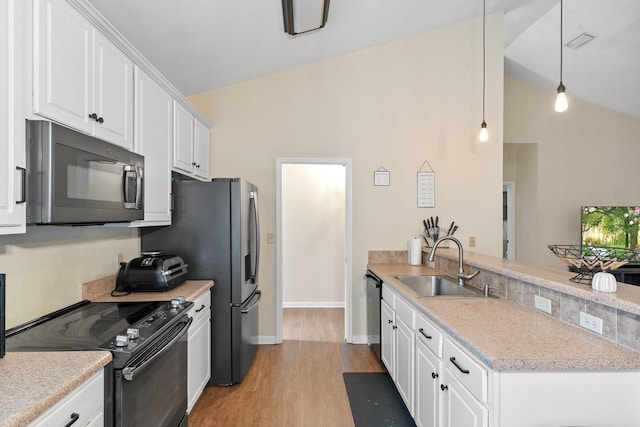 kitchen with lofted ceiling, sink, white cabinetry, electric range, and decorative light fixtures