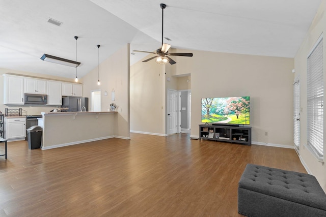 living room with wood-type flooring, high vaulted ceiling, and ceiling fan