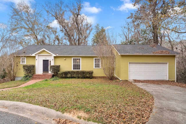 ranch-style house with a garage and a front lawn