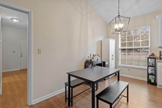 dining space featuring a notable chandelier and light wood-type flooring