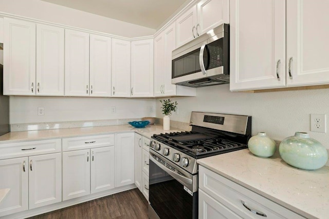 4468 River Breeze Ln, Tallahassee, FL 32303 - kitchen featuring appliances with stainless steel finishes, white cabinets, dark wood finished floors, and light stone counters