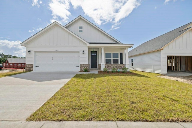 4468 River Breeze Ln, Tallahassee, FL 32303 - view of front facade featuring board and batten siding, a front yard, an attached garage, concrete driveway, and brick siding