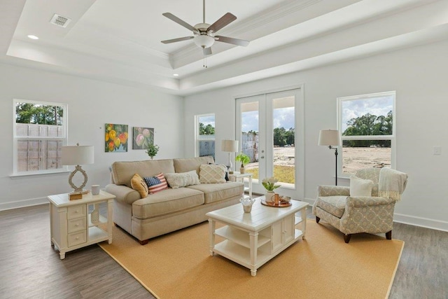 4468 River Breeze Ln, Tallahassee, FL 32303 - living area featuring wood finished floors, a tray ceiling, plenty of natural light, recessed lighting, and ornamental molding