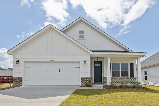 4468 River Breeze Ln, Tallahassee, FL 32303 - view of front of home featuring board and batten siding, brick siding, concrete driveway, an attached garage, and a front lawn