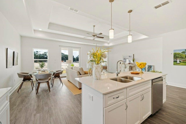 4468 River Breeze Ln, Tallahassee, FL 32303 - kitchen with dishwasher, a raised ceiling, a sink, dark wood-style floors, and an island with sink