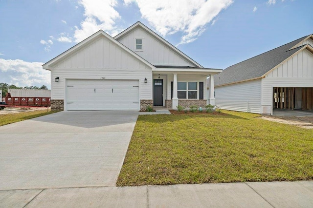 4468 River Breeze Ln, Tallahassee, FL 32303 - view of front of home with board and batten siding, a front lawn, brick siding, concrete driveway, and an attached garage