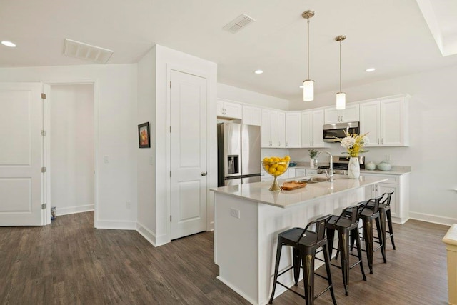4468 River Breeze Ln, Tallahassee, FL 32303 - kitchen featuring appliances with stainless steel finishes, baseboards, dark wood finished floors, a sink, and white cabinets