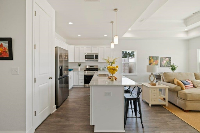 4468 River Breeze Ln, Tallahassee, FL 32303 - kitchen with appliances with stainless steel finishes, open floor plan, recessed lighting, dark wood-type flooring, and a kitchen bar