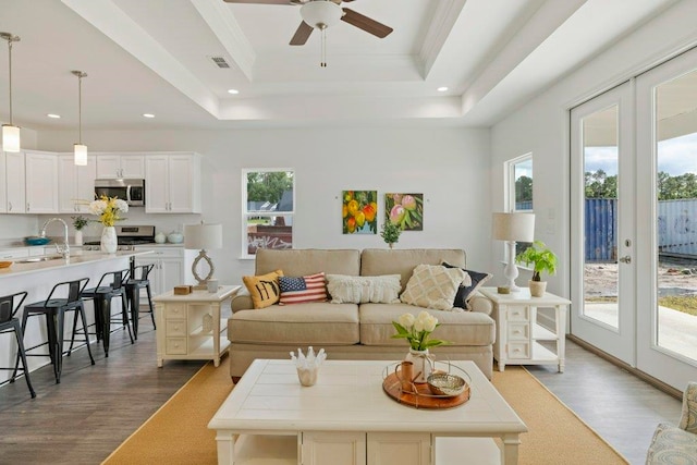 4468 River Breeze Ln, Tallahassee, FL 32303 - living area featuring dark wood-type flooring, a ceiling fan, a raised ceiling, and recessed lighting
