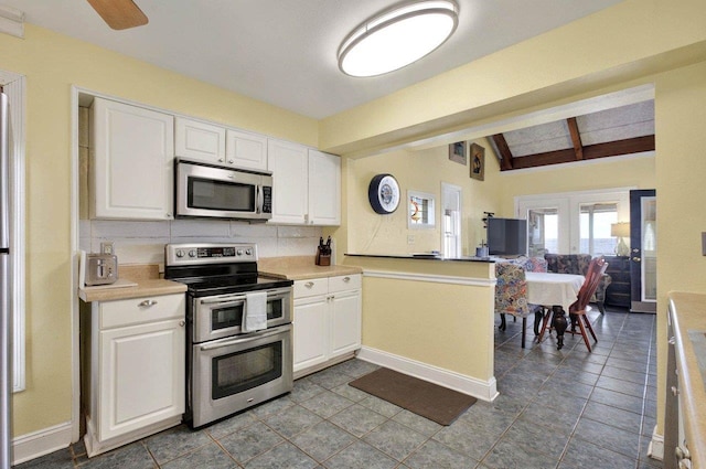 1195 Alligator Dr, Alligator Point, FL 32346 - kitchen with stainless steel appliances, white cabinets, and light countertops