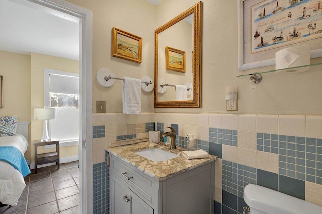 1195 Alligator Dr, Alligator Point, FL 32346 - half bath featuring toilet, vanity, tile walls, a wainscoted wall, and tile patterned flooring